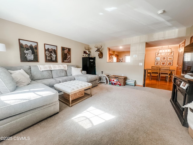 living room with carpet and a baseboard heating unit