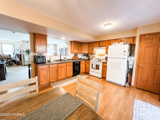 kitchen featuring white appliances, sink, and light wood-type flooring