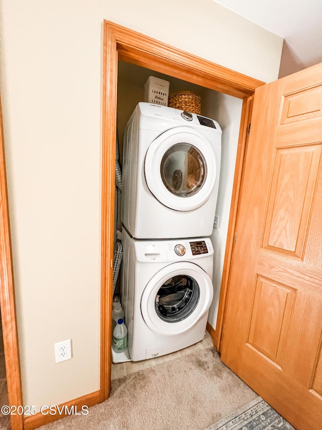 laundry area with stacked washer and dryer and light colored carpet