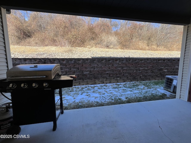 view of patio / terrace featuring cooling unit and a grill