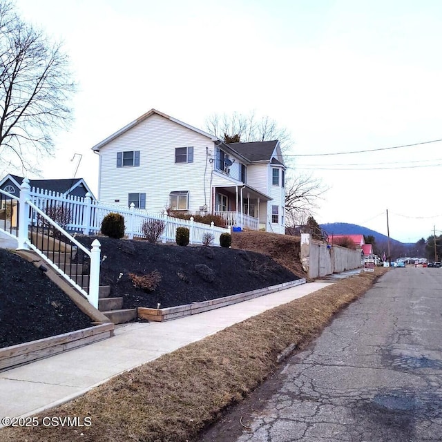 view of side of home featuring fence