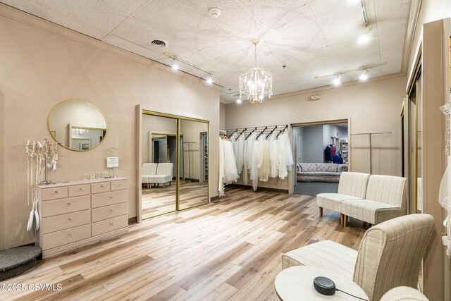 53 W Main St, Bloomsburg, PA 17815 - bedroom featuring track lighting, a notable chandelier, light hardwood / wood-style floors, and a closet