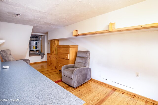 53 W Main St, Bloomsburg, PA 17815 - sitting room featuring hardwood / wood-style floors, electric water heater, and a textured ceiling