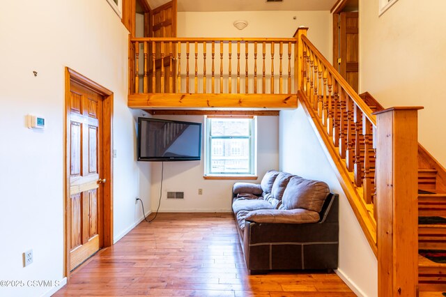 53 W Main St, Bloomsburg, PA 17815 - living room featuring a towering ceiling and light wood-type flooring