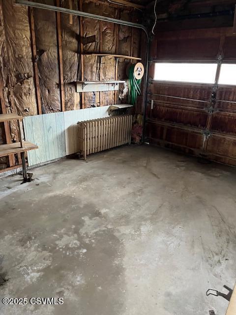 garage featuring radiator heating unit