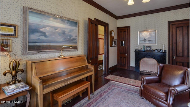 living area with dark wood-type flooring and ornamental molding