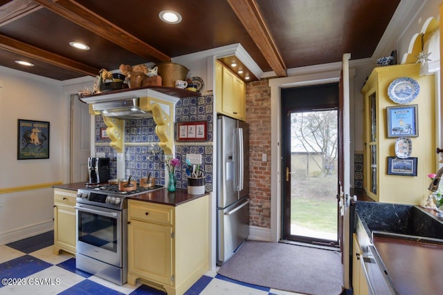 kitchen featuring appliances with stainless steel finishes, wall chimney range hood, beam ceiling, and decorative backsplash