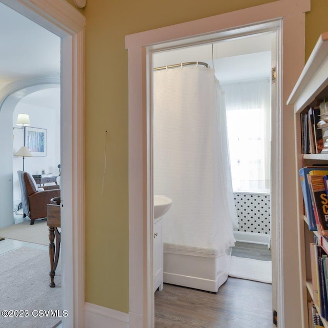 bathroom featuring vanity, hardwood / wood-style floors, and walk in shower