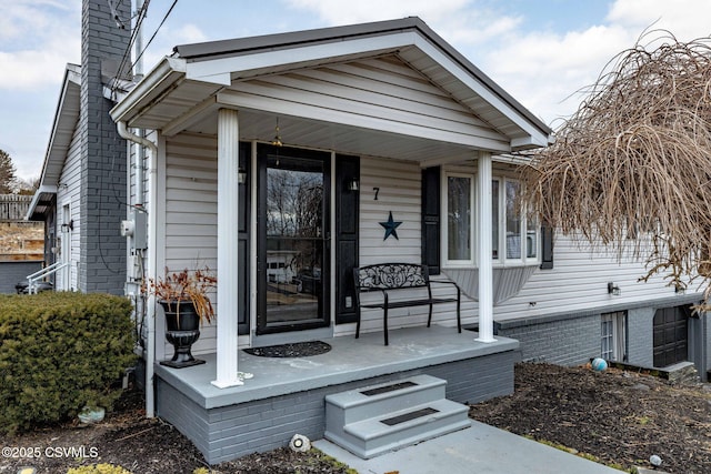 entrance to property featuring a porch