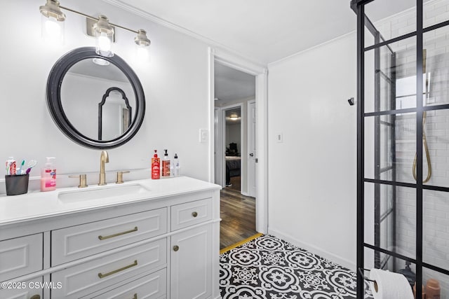 bathroom with vanity, wood-type flooring, and ornamental molding