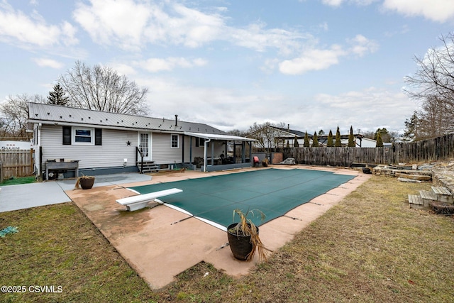 view of pool featuring a yard, a diving board, and a patio