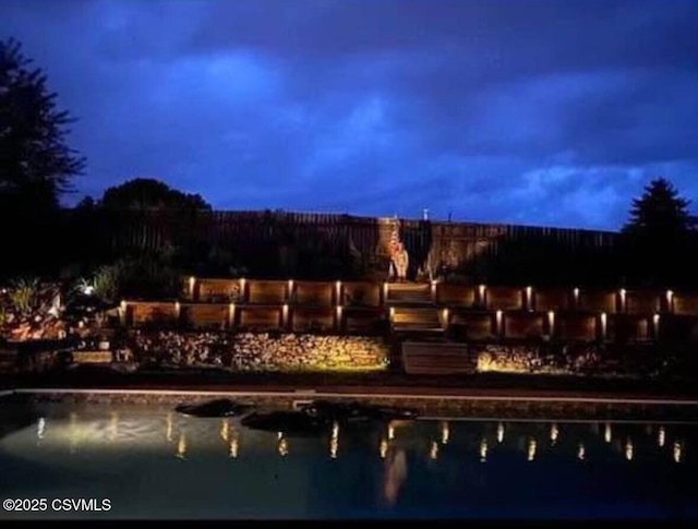 view of pool featuring a water view