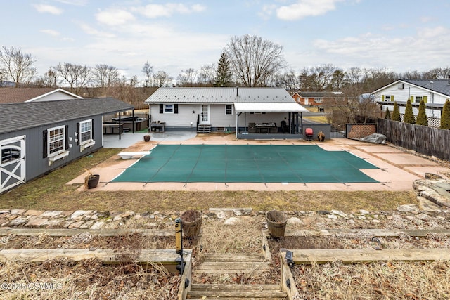 view of swimming pool featuring a diving board and a patio area