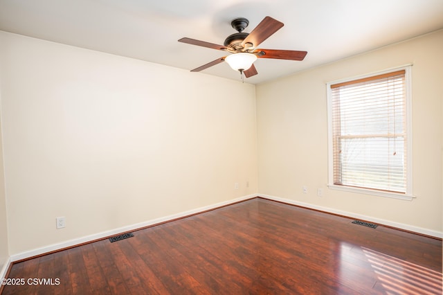 empty room with ceiling fan, visible vents, baseboards, and hardwood / wood-style floors