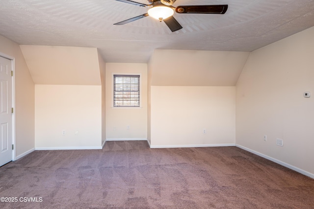 bonus room with baseboards, lofted ceiling, carpet, and ceiling fan