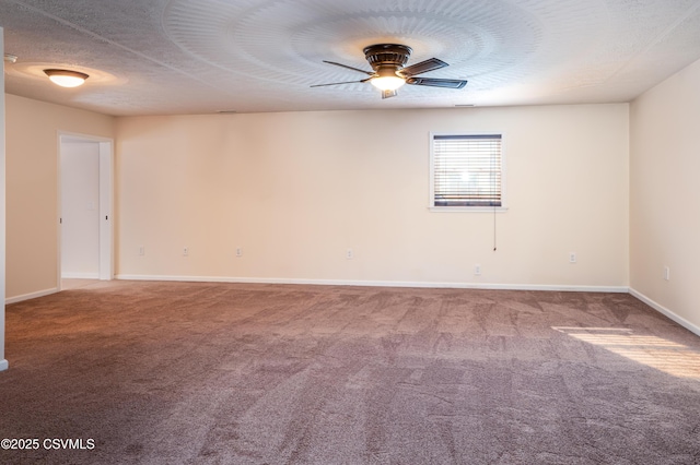 unfurnished room with ceiling fan, carpet flooring, baseboards, and a textured ceiling