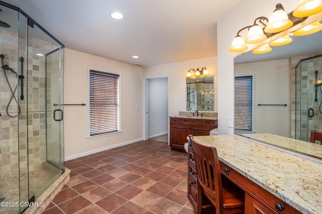 bathroom with tile patterned floors, recessed lighting, a shower stall, baseboards, and vanity