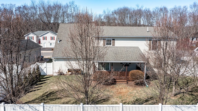 view of front of house with a porch, roof with shingles, fence private yard, and a gate