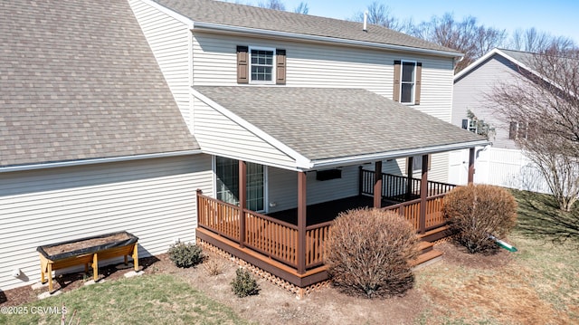 back of house featuring a wooden deck and a shingled roof