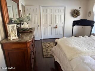 bedroom featuring a closet and dark wood-style floors