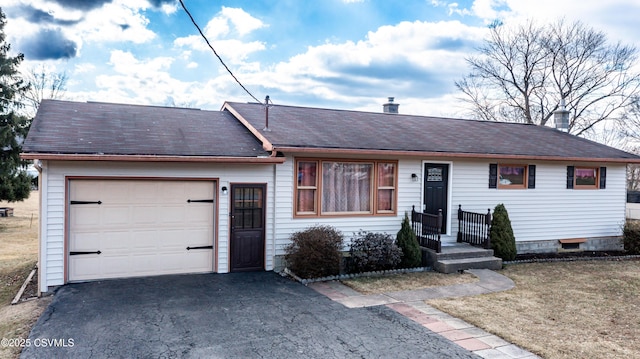 ranch-style home with driveway, an attached garage, and a shingled roof