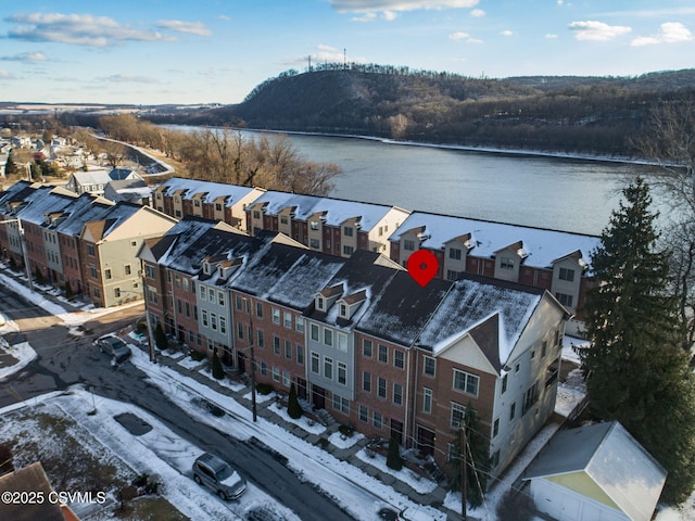 snowy aerial view featuring a water view