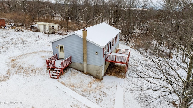 exterior space featuring a deck and a shed