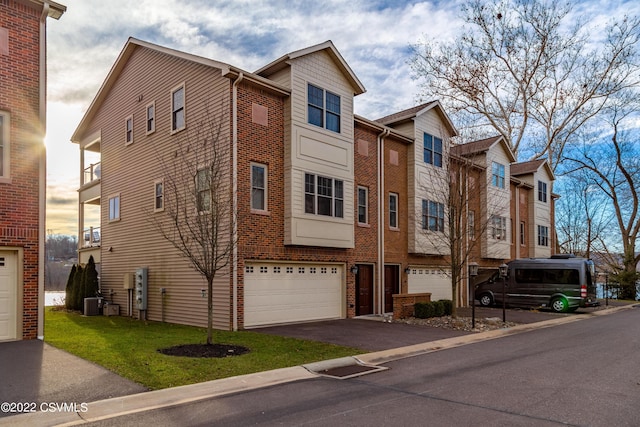 multi unit property featuring a garage and central air condition unit