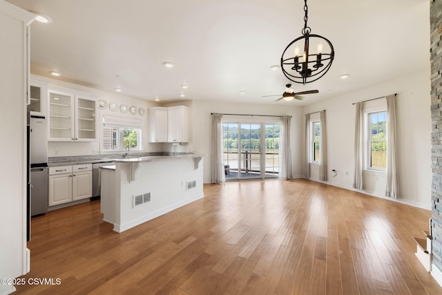 118 Jacobs Landing Way, Danville, PA 17821 - kitchen featuring a kitchen bar, stainless steel dishwasher, white cabinets, a chandelier, and recessed lighting
