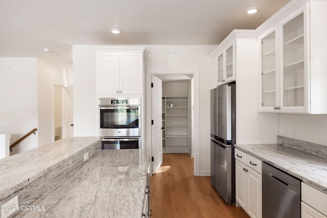 118 Jacobs Landing Way, Danville, PA 17821 - kitchen with stainless steel appliances, white cabinets, light wood-style flooring, light stone counters, and recessed lighting