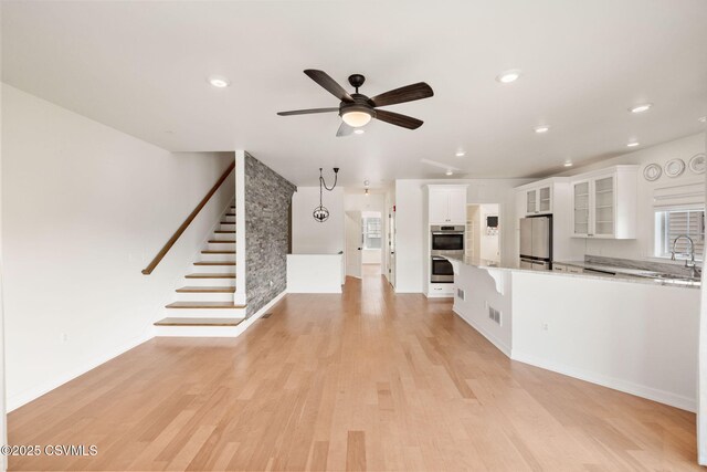 118 Jacobs Landing Way, Danville, PA 17821 - kitchen featuring freestanding refrigerator, double oven, white cabinetry, a ceiling fan, and light wood-type flooring
