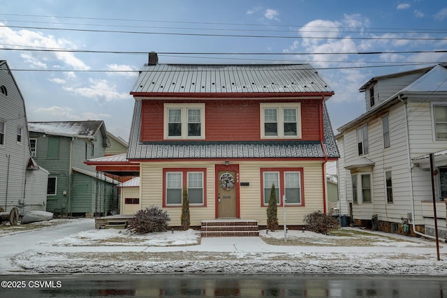 view of front of home with metal roof and a chimney