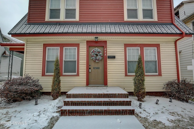 view of snow covered property entrance