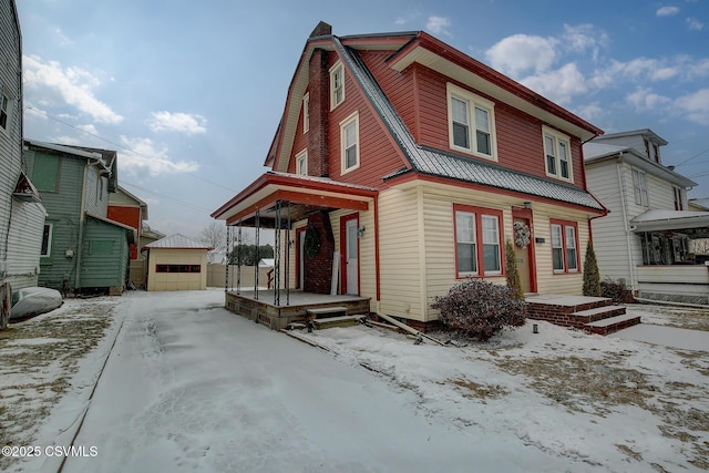 view of front of house featuring a garage and an outdoor structure