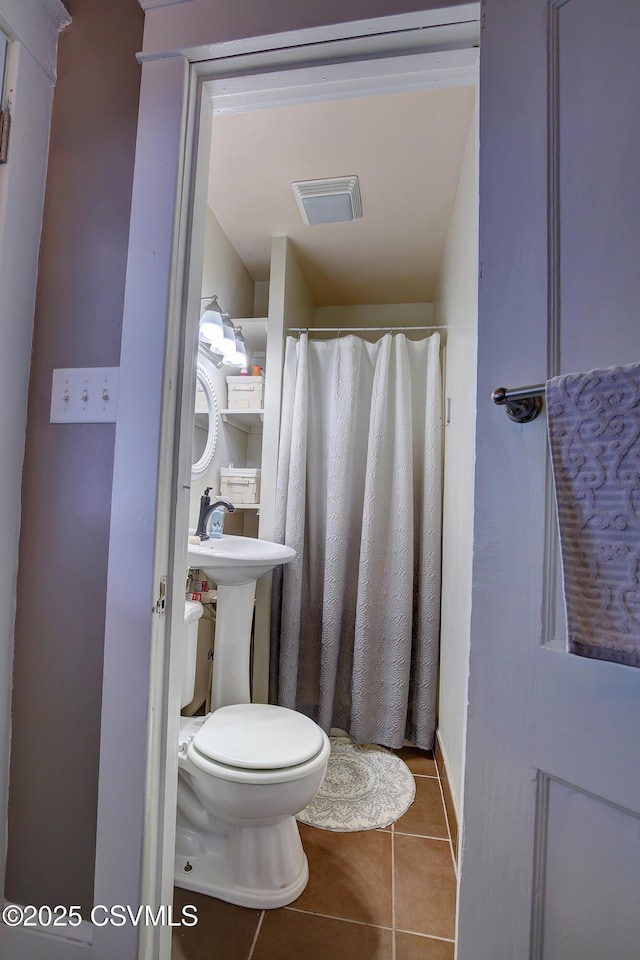 full bathroom featuring toilet, visible vents, and tile patterned floors