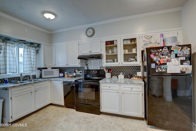 kitchen featuring white cabinetry, a sink, under cabinet range hood, and black appliances