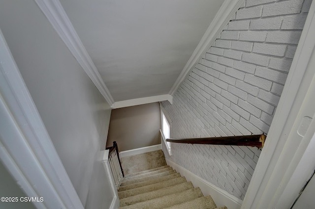 stairs featuring baseboards and ornamental molding