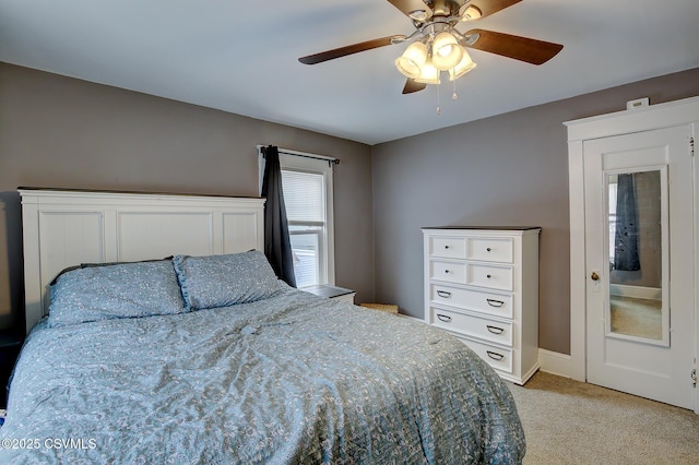 bedroom with light colored carpet and ceiling fan