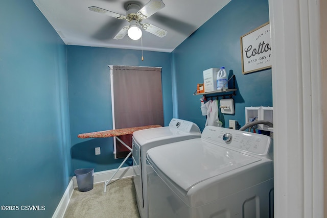 clothes washing area featuring ceiling fan, laundry area, carpet floors, baseboards, and washer and dryer