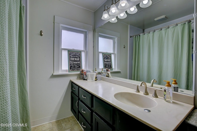 full bath featuring visible vents, vanity, and baseboards