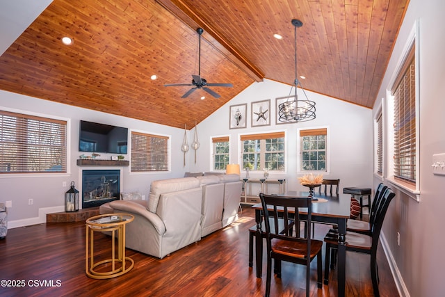 dining space featuring dark wood-type flooring, a tile fireplace, wooden ceiling, and beam ceiling