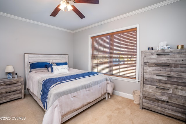 bedroom featuring light carpet, ceiling fan, baseboards, and crown molding