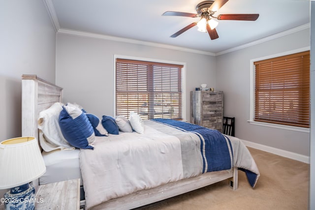 carpeted bedroom with baseboards, ceiling fan, and crown molding