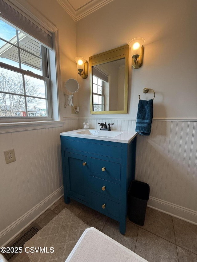 bathroom featuring wainscoting, vanity, a wealth of natural light, and tile patterned floors