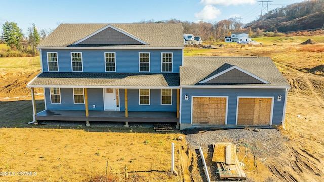 view of front of property with covered porch, roof with shingles, and an attached garage