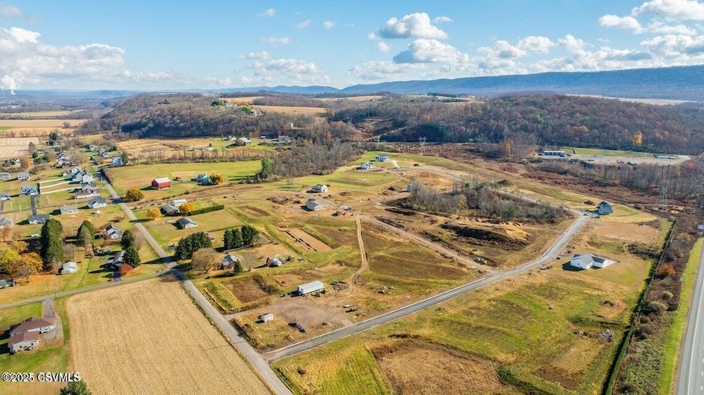 drone / aerial view featuring a rural view and a mountain view