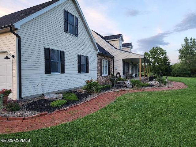 exterior space featuring a front lawn and a garage