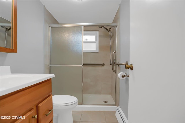 bathroom with a stall shower, a baseboard radiator, tile patterned flooring, and vanity