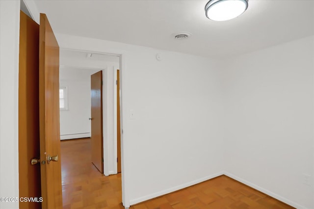 unfurnished room featuring a baseboard radiator, visible vents, baseboards, and parquet flooring