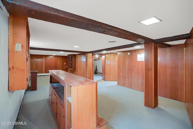 interior space with wood walls and light colored carpet